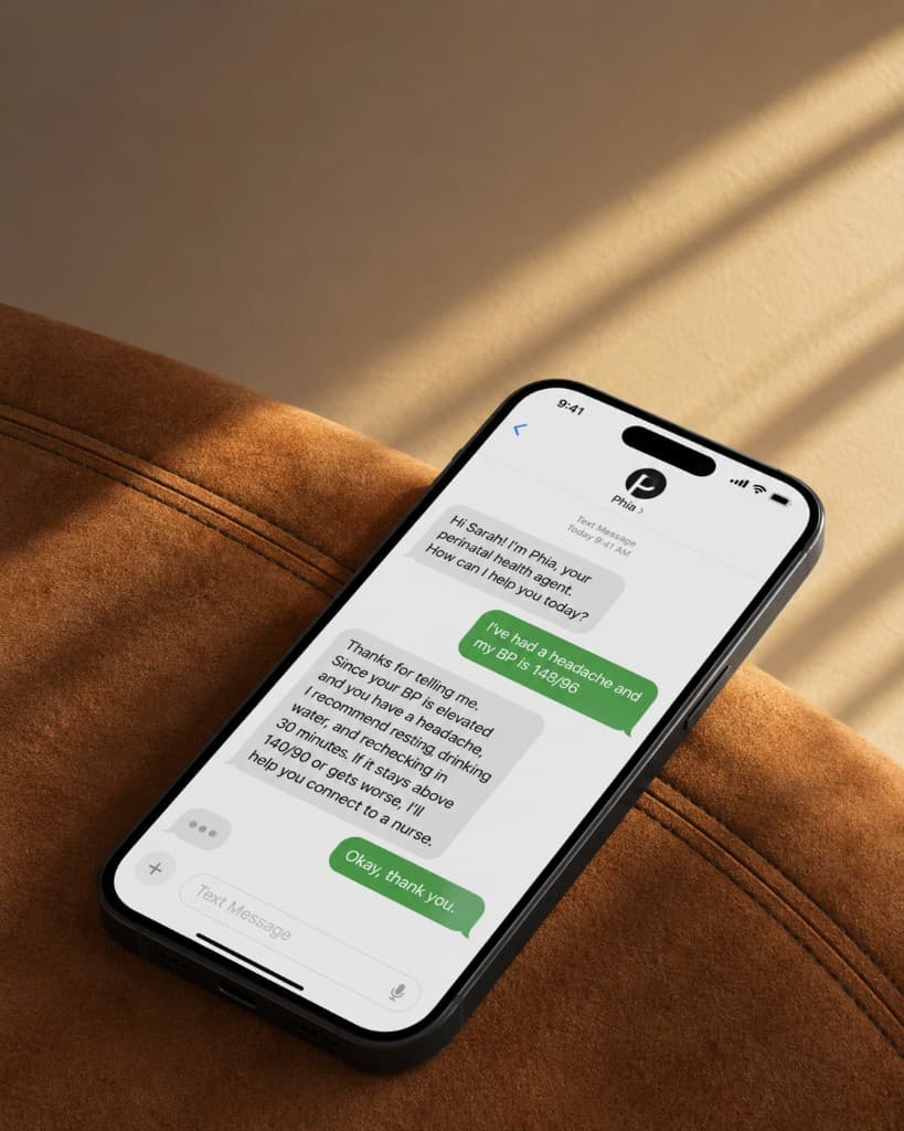 A phone resting on a suede chair, showing a text conversation with Phia
